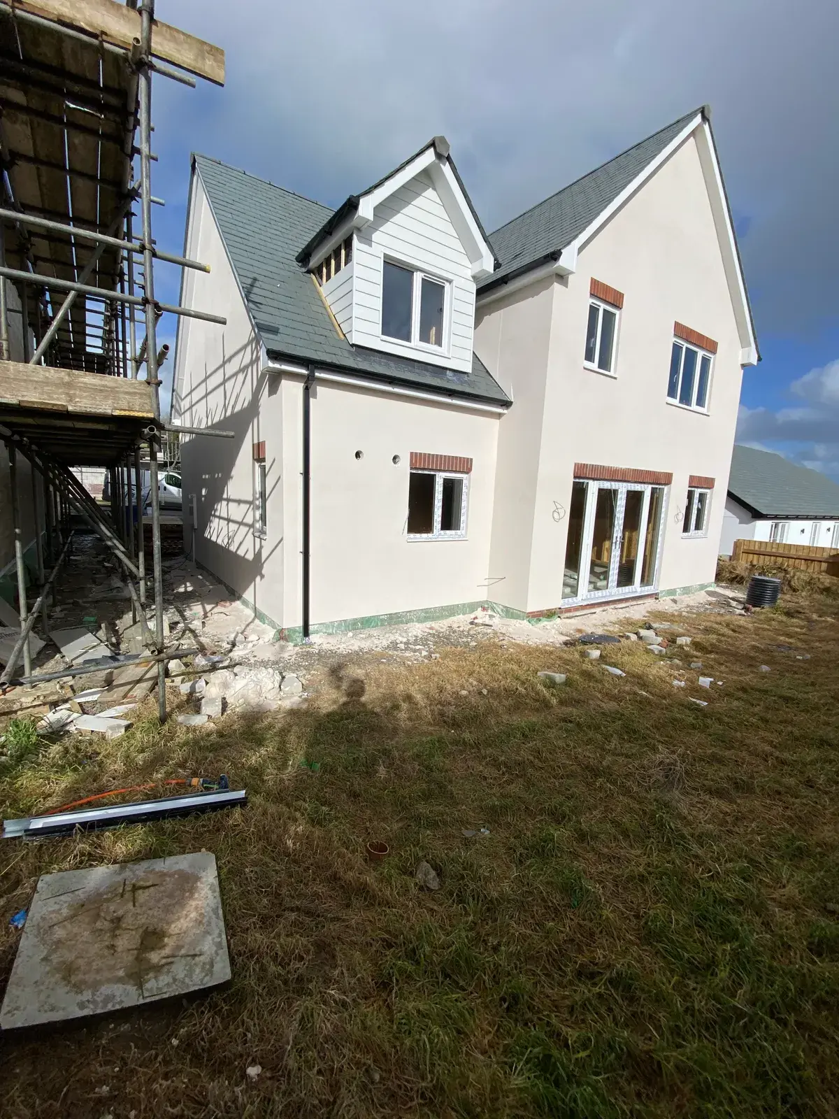 Monocouche render being applied to a house from scaffolding