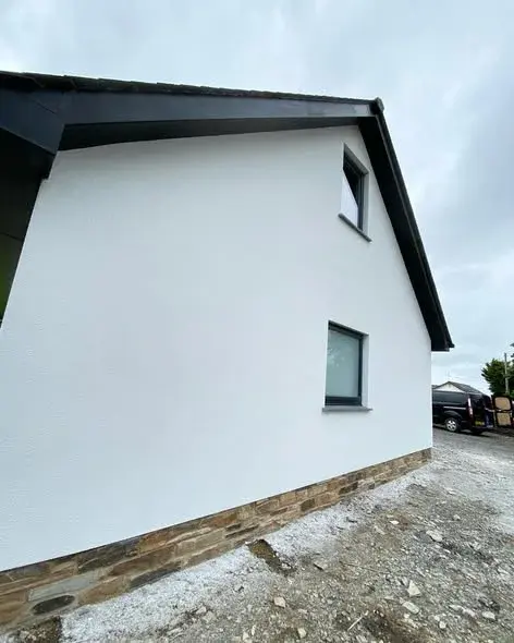 Crisp white render gable with a stone plinth, by PureRend